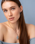 Load image into Gallery viewer, Teardrop-shaped blue gemstone necklace on a model neck