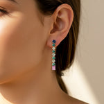 Load image into Gallery viewer, Pair of earrings with colored gemstones on a model ear