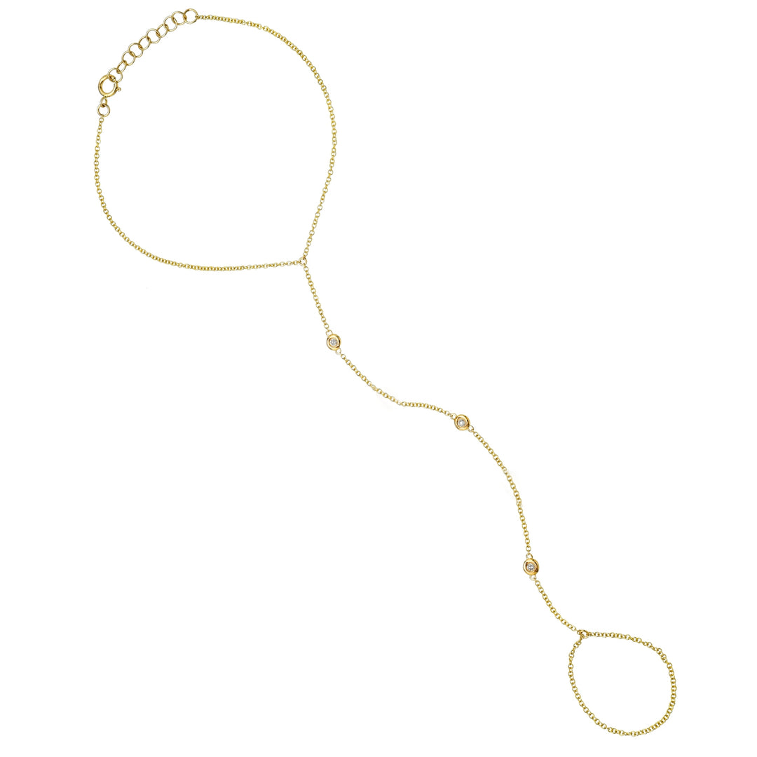 A yellow gold hand bracelet and ring chain with sparkling diamonds, featuring a seamless design.