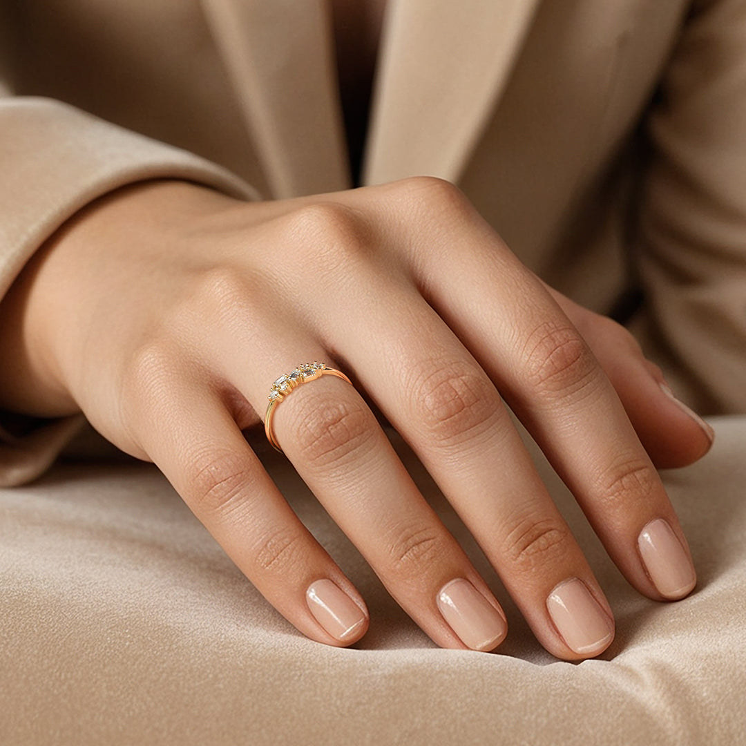 Gold ring with diamond accents on female model hand