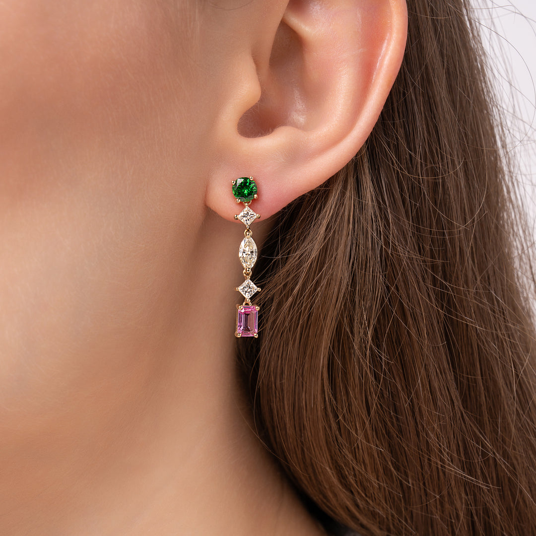 Gold dangle earrings with green, pink, and clear gemstones on a white background