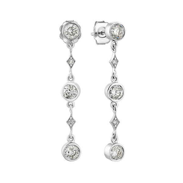 Silver earrings with clear gemstones on a white background