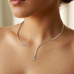 Load image into Gallery viewer, Silver wire necklace with small diamond pendants on a model neck