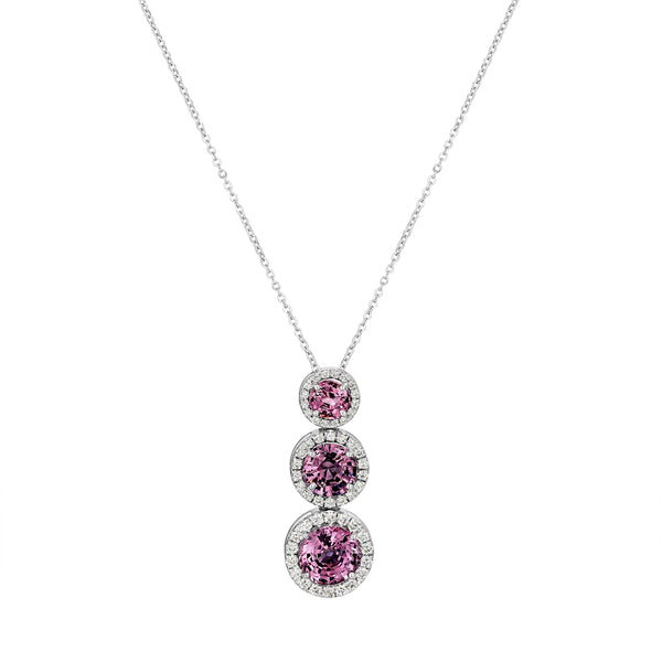 Necklace with three purple gemstones on a white background