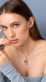 Load image into Gallery viewer, Teardrop-shaped blue gemstone necklace on a model neck