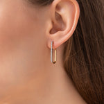 Load image into Gallery viewer, Gold hoop earrings with diamond accents on a model ear