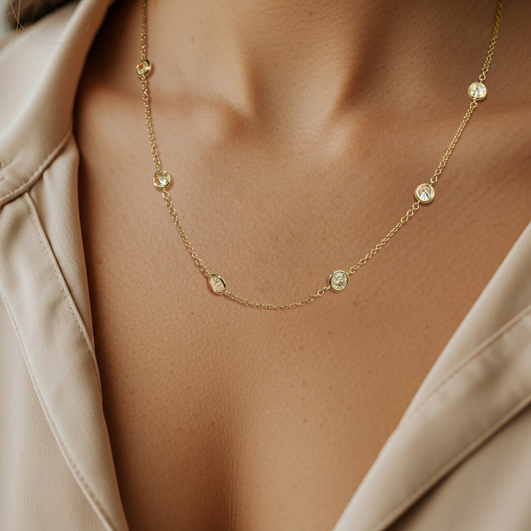 Gold necklace with small diamonds on model neck
