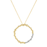 Load image into Gallery viewer, Gold necklace with a circular pendant on a white background