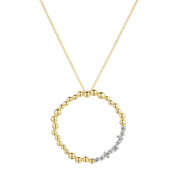Gold necklace with a circular pendant on a white background
