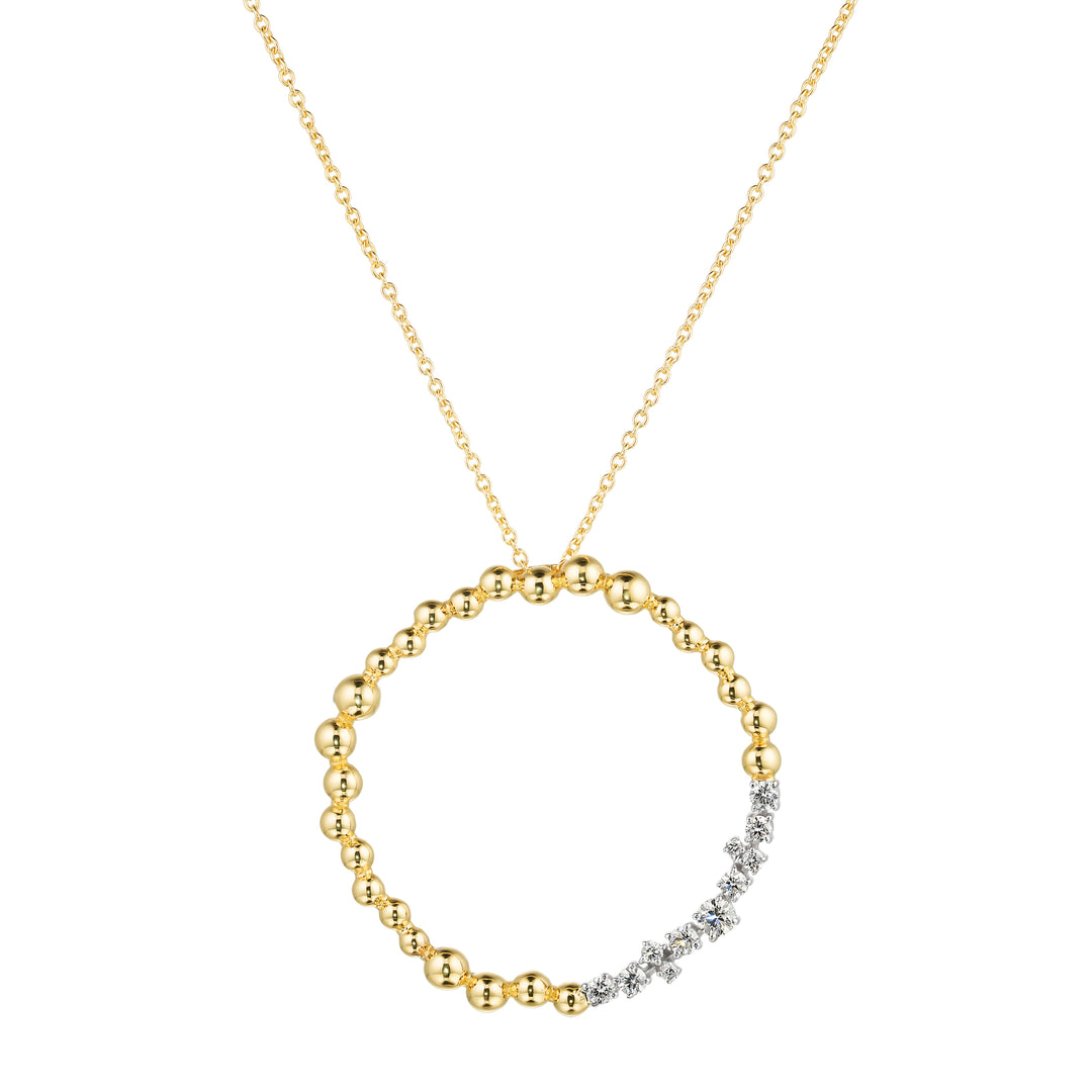Gold necklace with a circular pendant on a white background