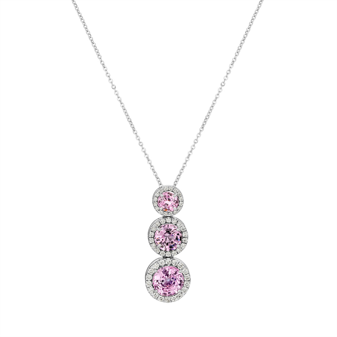Necklace with three pink gemstones on a white background