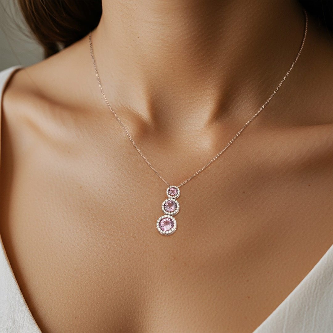 Necklace with three pink gemstones on a model neck