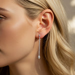 Load image into Gallery viewer, Pair of long diamond earrings on a model ear