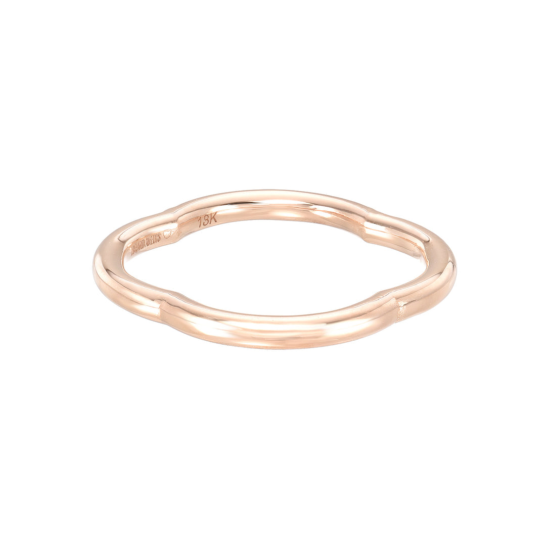 A rose gold band eternity ring with small inset stones around the entire circumference.