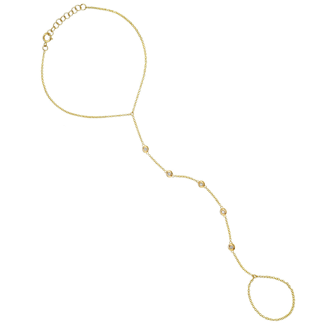 Dainty diamond hand chain in yellow gold on white background