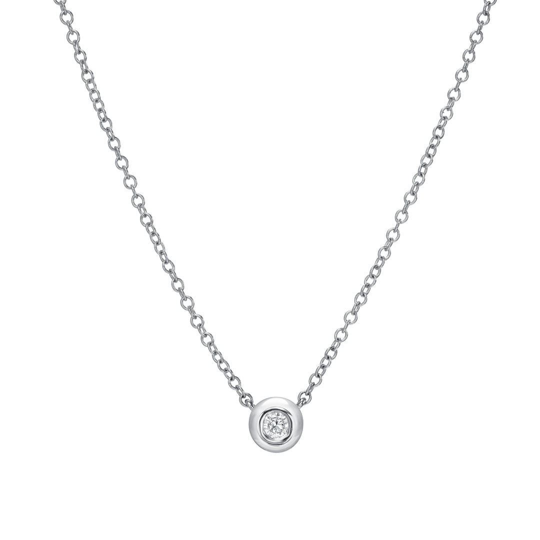Silver necklace with a small round pendant on a white background