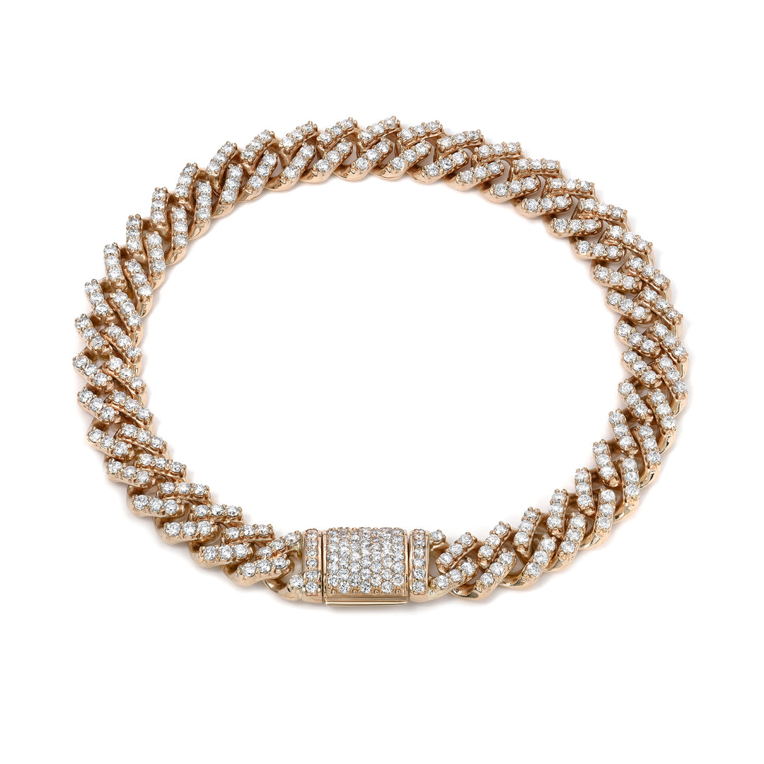 Yellow gold bracelet with diamond accents on a white background