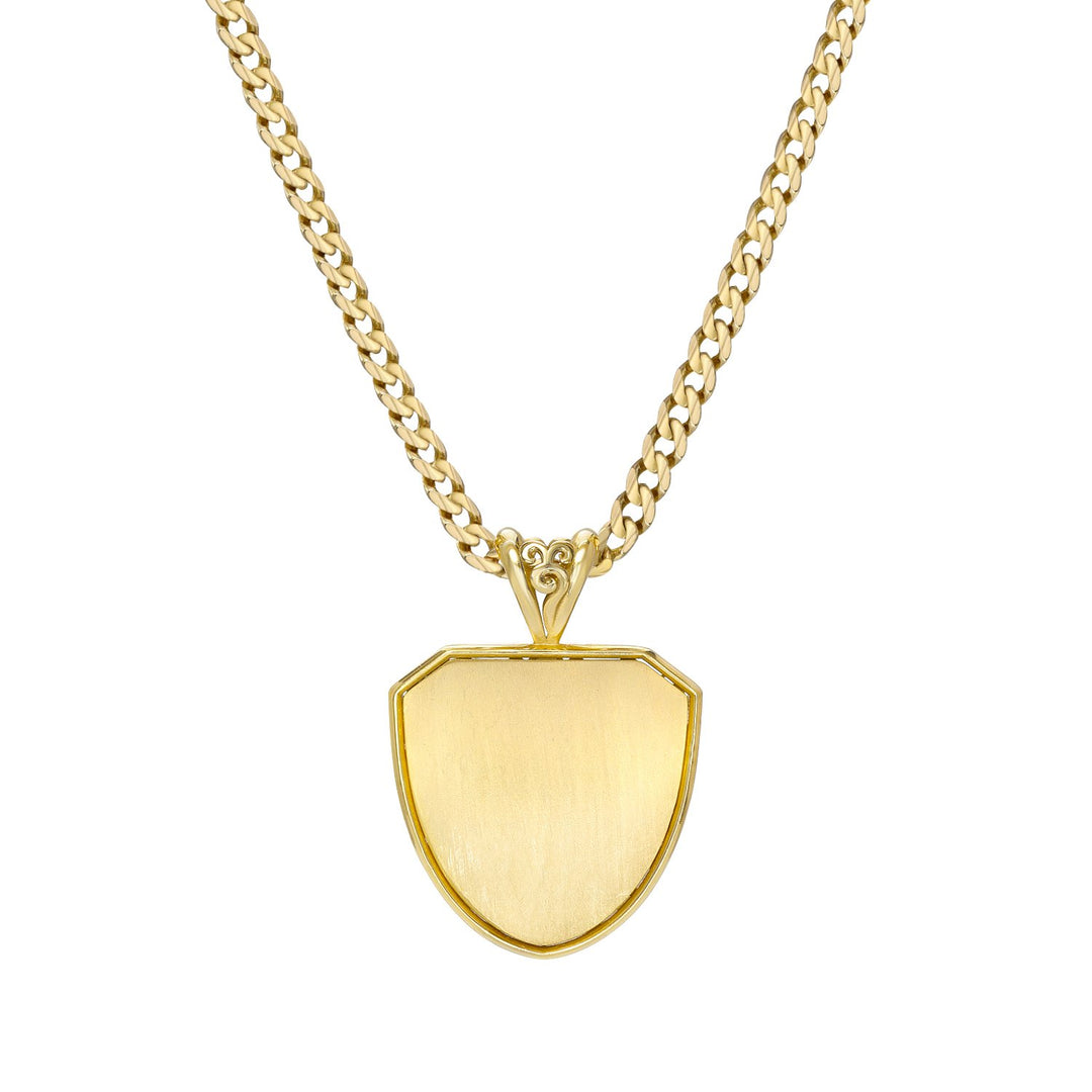 Gold necklace with a detailed shield-shaped pendant back on a white background