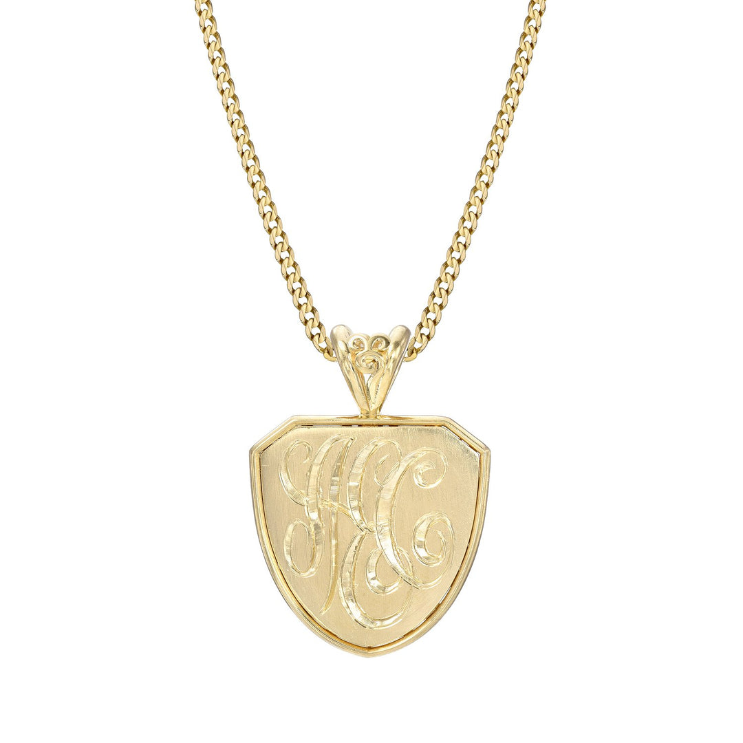 Yellow gold necklace with a detailed shield-shaped custom pendant on a white background