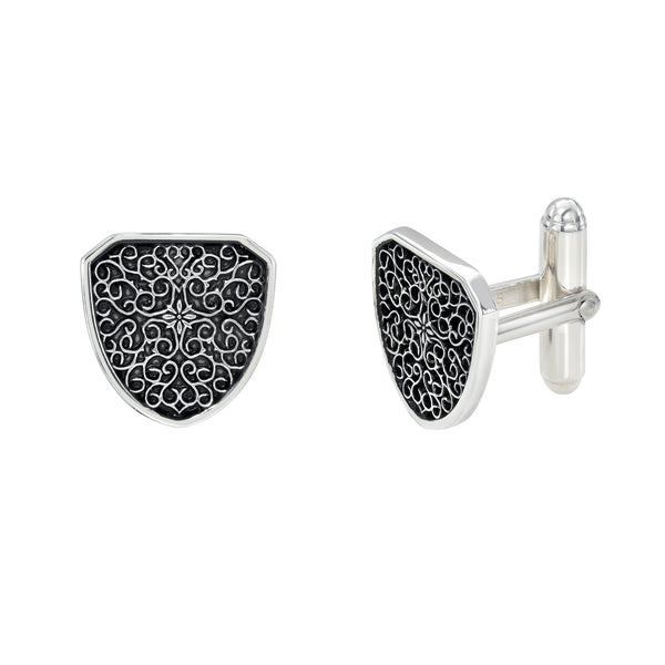 Gold cufflinks with intricate black design on a white background