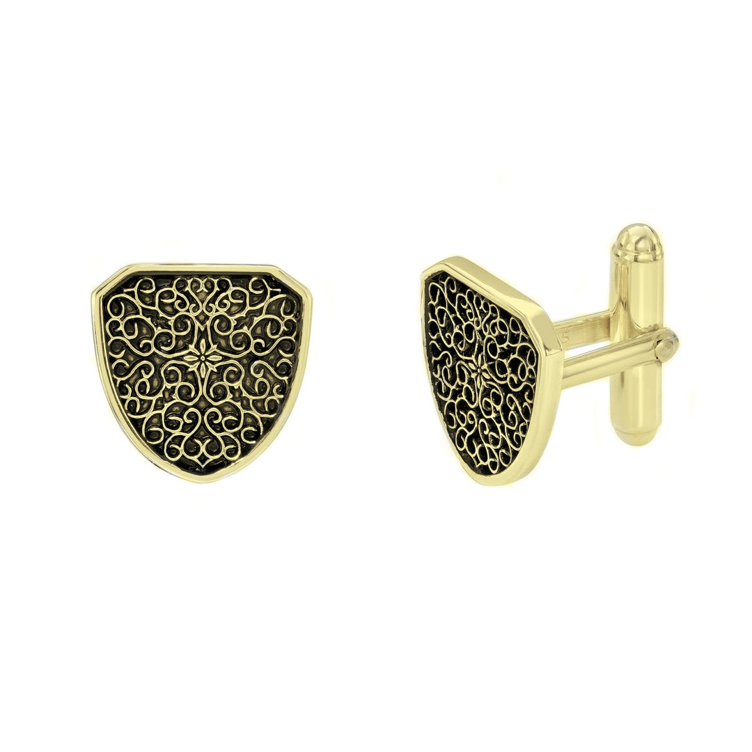 Gold cufflinks with intricate black design on a white background