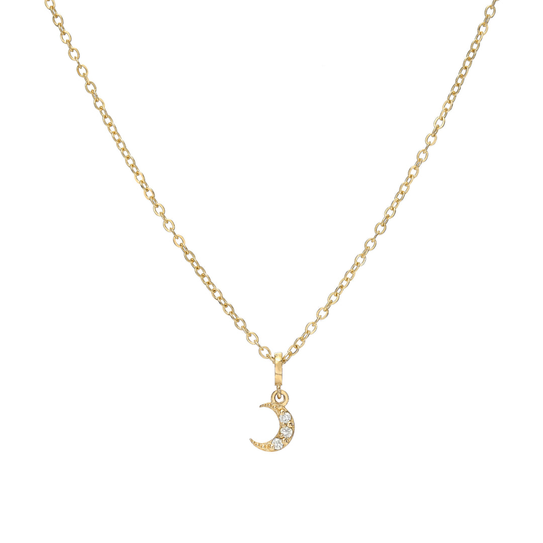Gold necklace with a crescent moon pendant on a white background