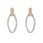 Load image into Gallery viewer, Pair of hoop earrings with rose gold and silver accents on a white background
