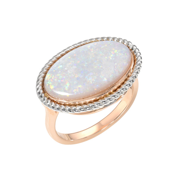 Ring with a large opal stone and rose gold band on a white background