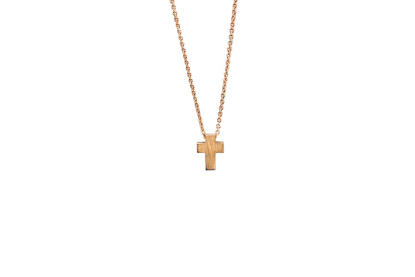 Gold cross necklace on a white background